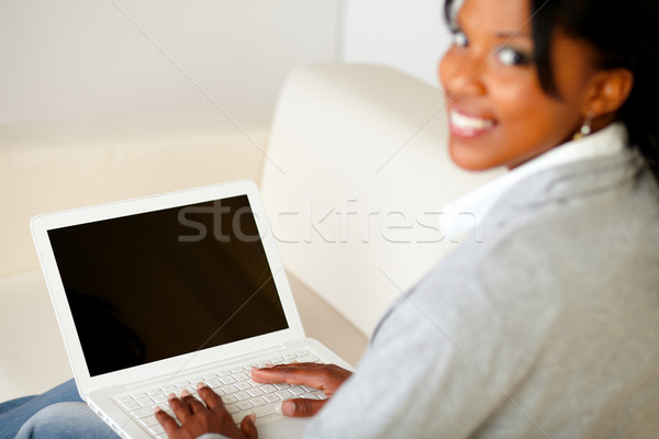 Stock photo: Attractive young woman using laptop