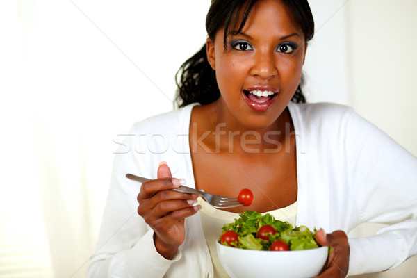 Surprised young woman eating fresh vegetable salad Stock photo © pablocalvog