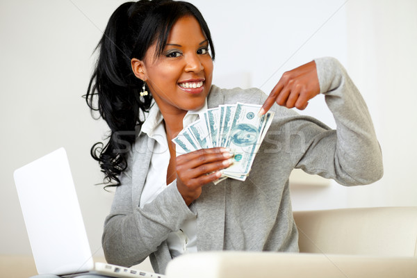 Happy woman pointing plenty of cash money Stock photo © pablocalvog