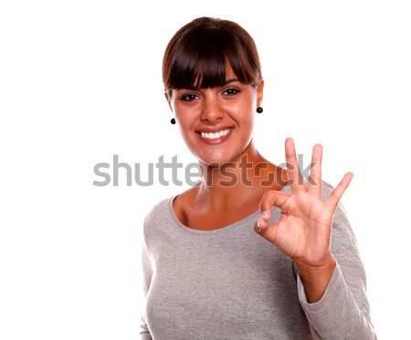 Smiling young woman saying great job with her hand Stock photo © pablocalvog