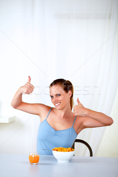 Happy young woman eating healthy breakfast Stock photo © pablocalvog