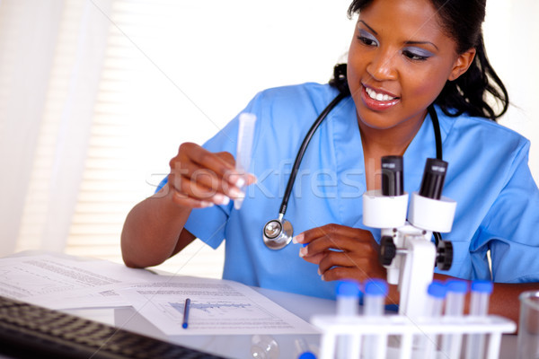 Belo enfermeira trabalhando test tube azul uniforme Foto stock © pablocalvog