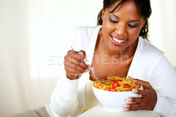 Smiling afro-american woman having breakfast Stock photo © pablocalvog
