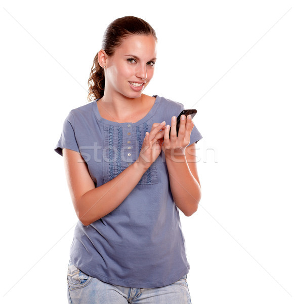 Woman looking at you sending message by cellphone Stock photo © pablocalvog