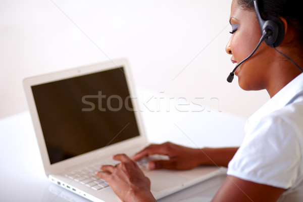 Stock photo: Pretty young woman working on customer service