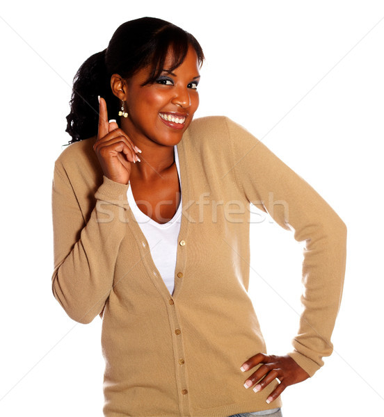 Atrakcyjny czarnej kobiety wskazując w górę patrząc tle Zdjęcia stock © pablocalvog