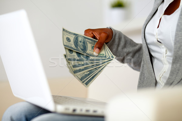 Afro-american woman holding plenty of cash money Stock photo © pablocalvog