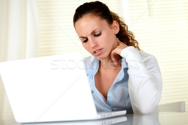 Young woman interested reading the laptop screen Stock photo © pablocalvog