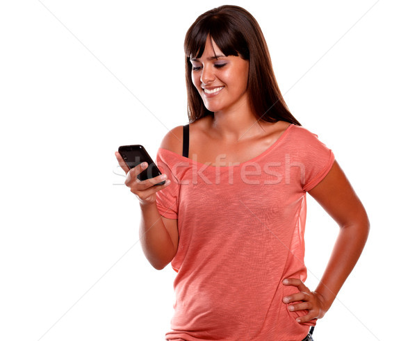 Charming young woman sending message by cellphone Stock photo © pablocalvog