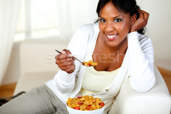 Stock photo: Young woman smiling at you and having breakfast