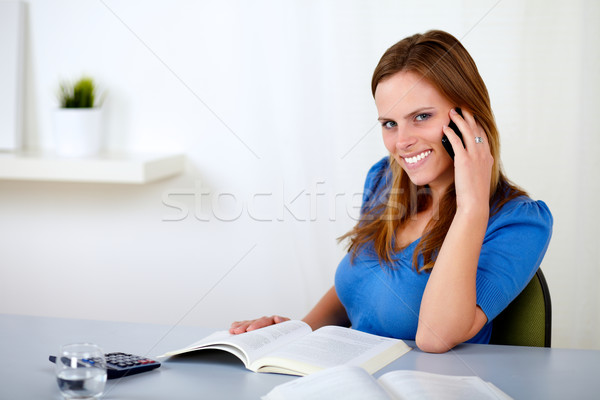 Pretty young girl speaking and browsing a book Stock photo © pablocalvog