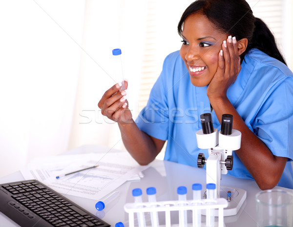 Podniecony naukowy kobieta patrząc probówki laboratorium Zdjęcia stock © pablocalvog