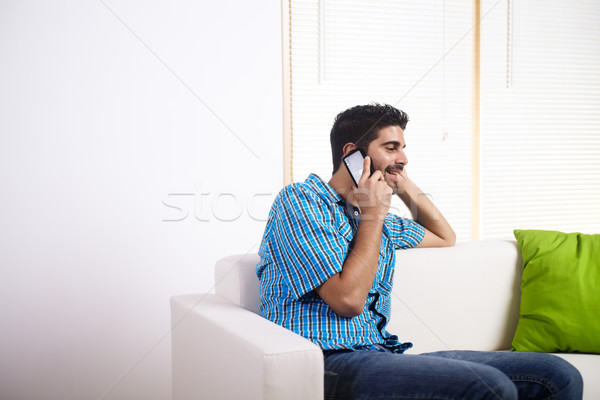 Stock photo: Young man talking on the mobile phone