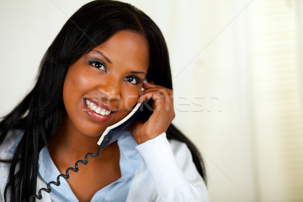 Stock photo: Happy young female speaking on phone