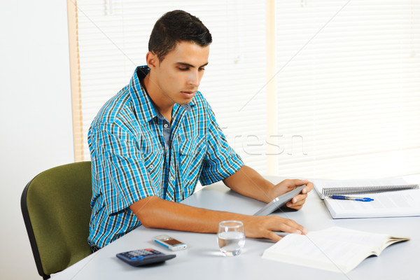 Young man studying with a tablet PC Stock photo © pablocalvog