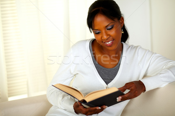 Young pretty woman browsing a book Stock photo © pablocalvog