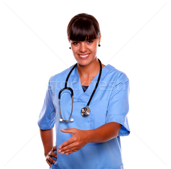 Smiling latin young nurse extending handshake Stock photo © pablocalvog