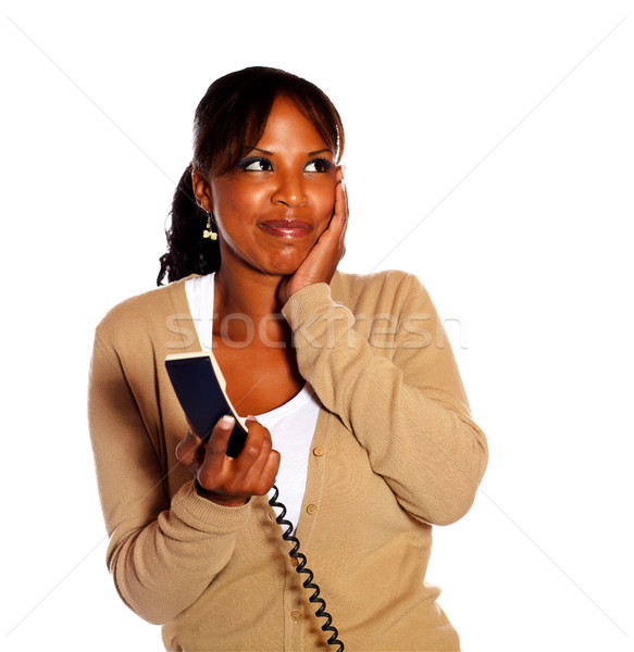 Smiling young female holding phone handset Stock photo © pablocalvog