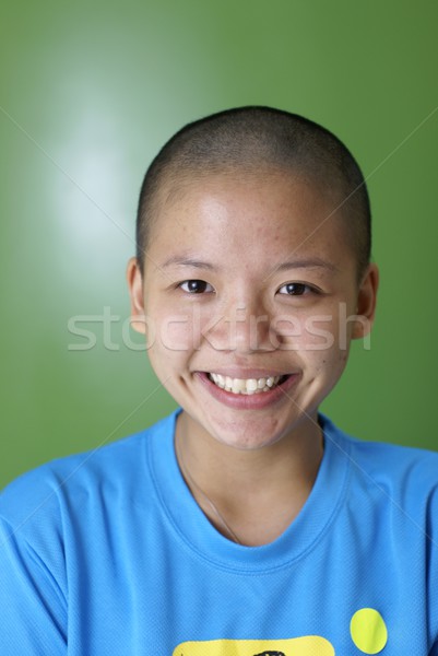 Happy lady with just shaved head and hair particles over face Stock photo © palangsi
