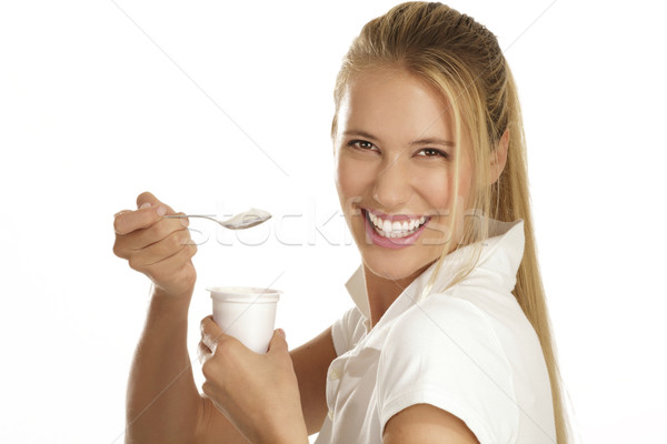 Mangiare yogurt bianco donna sorriso Foto d'archivio © paolopagani