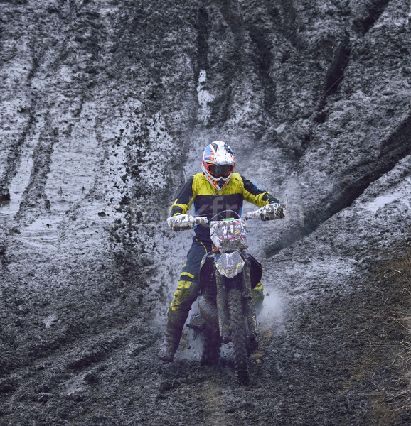 motorcyclist overcomes the obstacle of mud Stock photo © papa1266