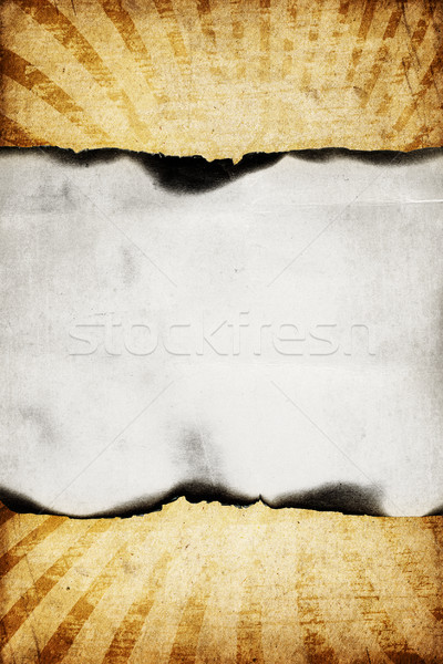 Vintage burned paper on sunburst background. Stock photo © pashabo