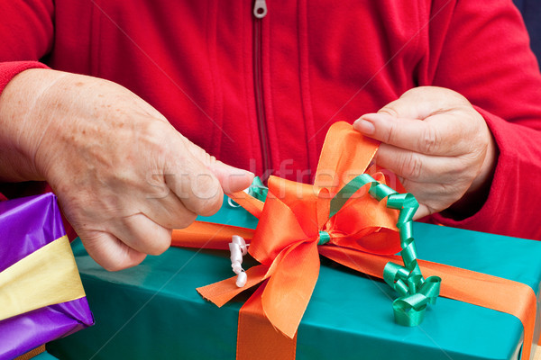 Stock photo: senior citizen wrap or unpack gifts