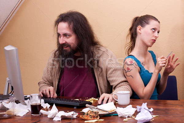 Long haired nerd on the computer with  beautiful woman Stock photo © Pasiphae