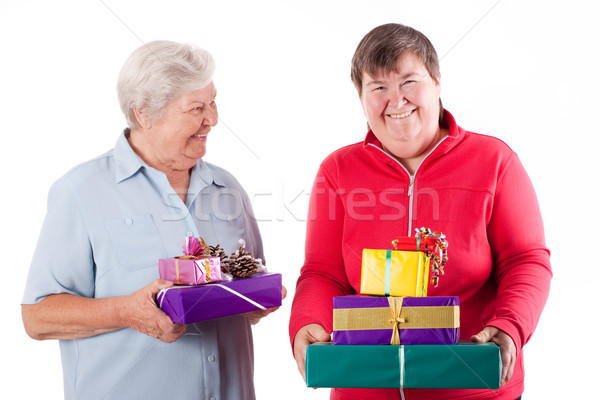 Stock photo: Female senior and mental disabled woman holding gifts
