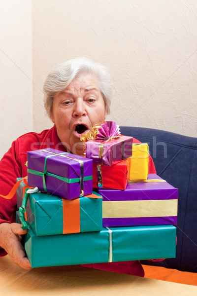 senior sitting on the couch with gifts Stock photo © Pasiphae