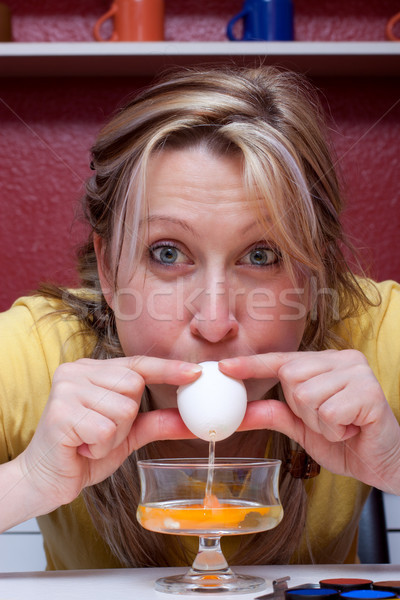 blonde woman blows out an egg Stock photo © Pasiphae