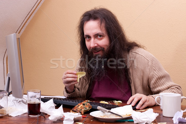 longhaired unkempt man sitting at the computer Stock photo © Pasiphae