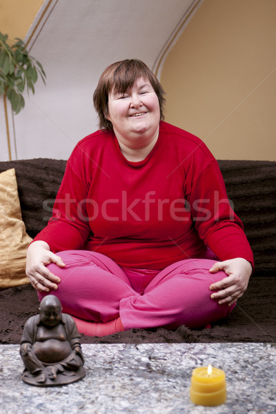 Handicapped woman sitting cross-legged on the couch Stock photo © Pasiphae