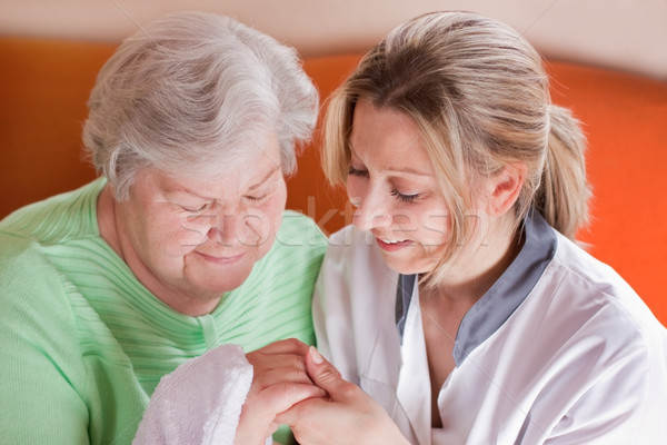 nurse washes hands of an elderly woman Stock photo © Pasiphae
