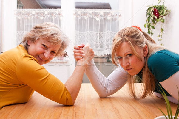 Stock photo:  mother and daughter measure the forces