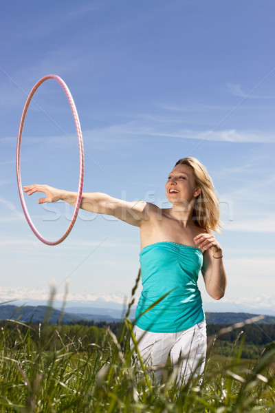 Blond mature womanplays with hula hoop Stock photo © Pasiphae