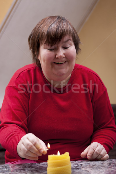 Mentally disabled woman lights a candle Stock photo © Pasiphae