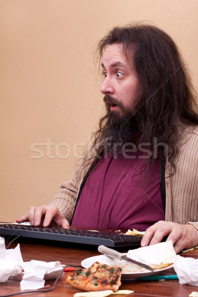 unkempt thick nerd sitting at a desk Stock photo © Pasiphae