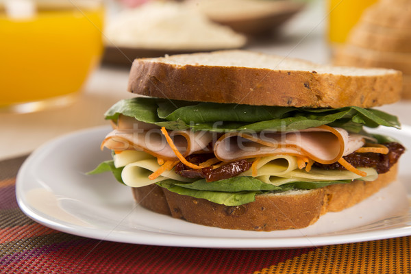 Sandwich on a white plate with turkey breast, tomato, lettuce an Stock photo © paulovilela