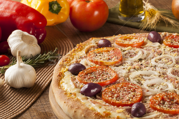 Traditional italian pizza on wooden. Stock photo © paulovilela