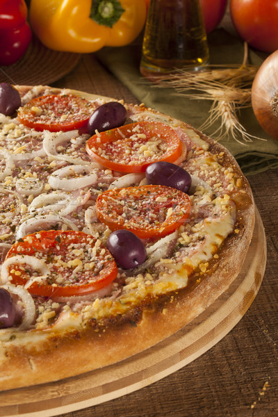 Traditional italian pizza on wooden. Stock photo © paulovilela