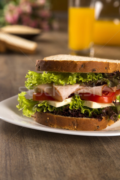 Sandwich on a white plate with turkey breast, tomato, lettuce an Stock photo © paulovilela