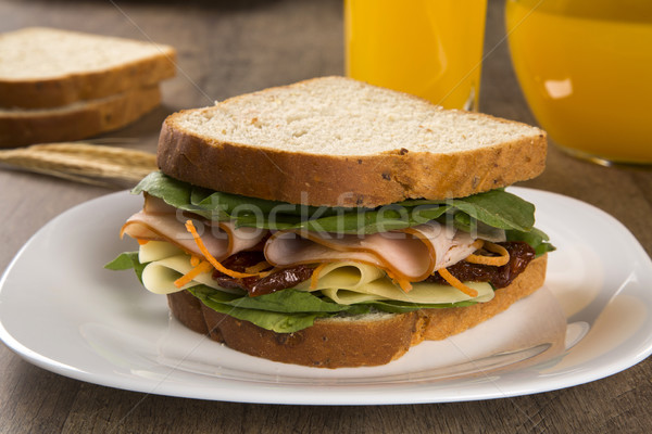 Sandwich on a white plate with turkey breast, tomato, lettuce an Stock photo © paulovilela