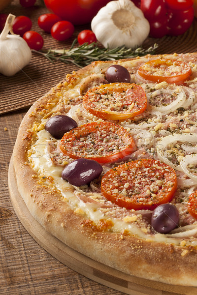 Traditional italian pizza on wooden. Stock photo © paulovilela