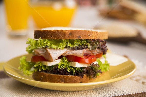 Sandwich on a white plate with turkey breast, tomato, lettuce an Stock photo © paulovilela