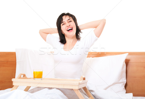 Bela mulher cama bandeja vidro laranja Foto stock © pekour