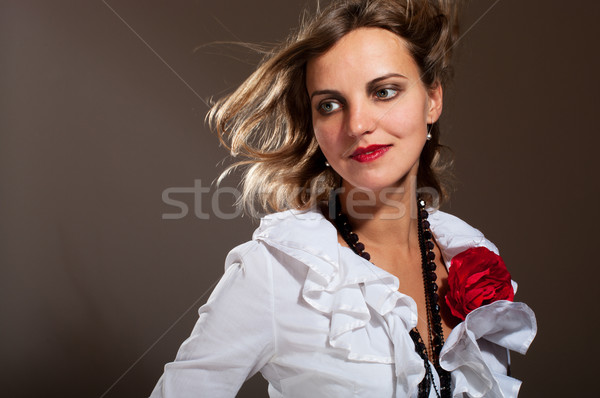 Daydreamed woman in white blouse with red flower Stock photo © pekour