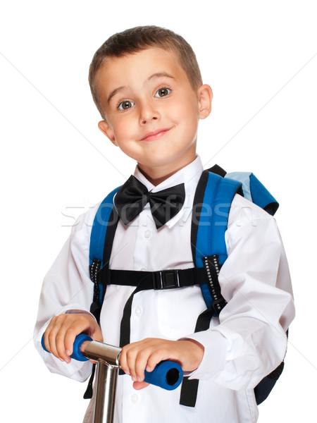 Elementary student boy with backpack and scooter Stock photo © pekour