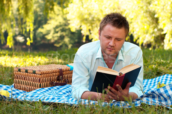 Young man reads book Stock photo © pekour