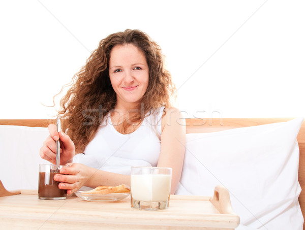 Redhead woman having breakfast milk toast chocolate butter in be Stock photo © pekour
